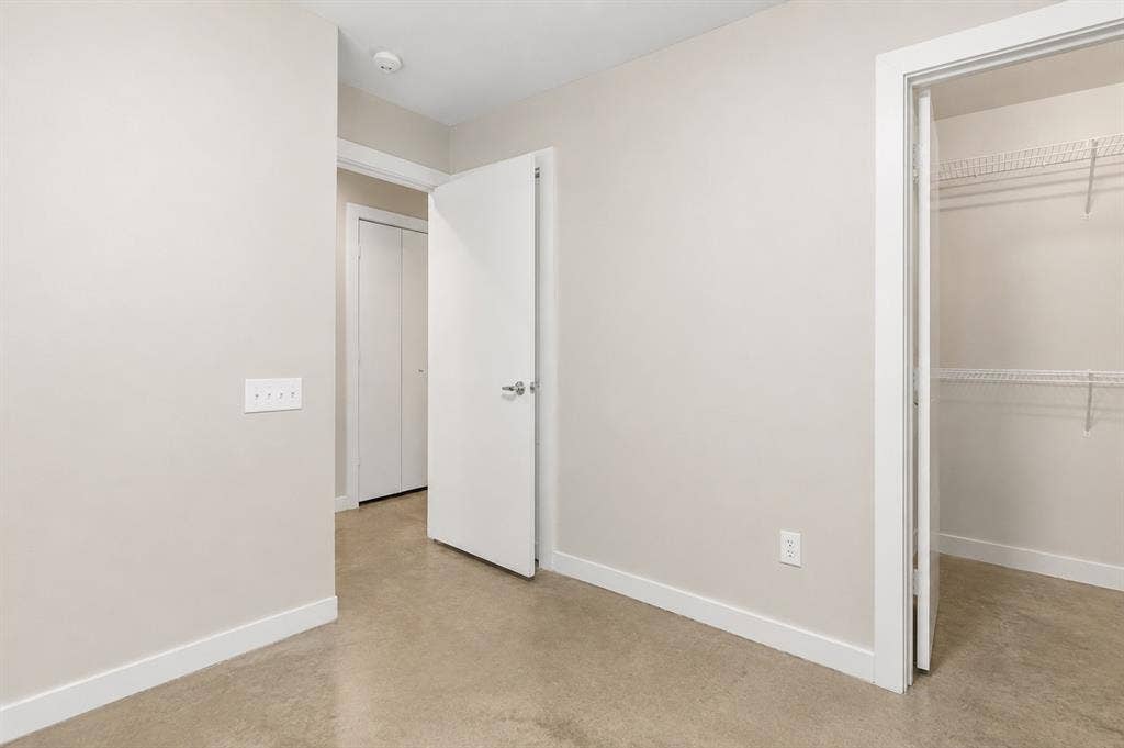 2714 Shelby Avenue, Dallas, TX 75219 Neutral wall tones, durable concrete flooring, white trim, and a wire shelving closet system