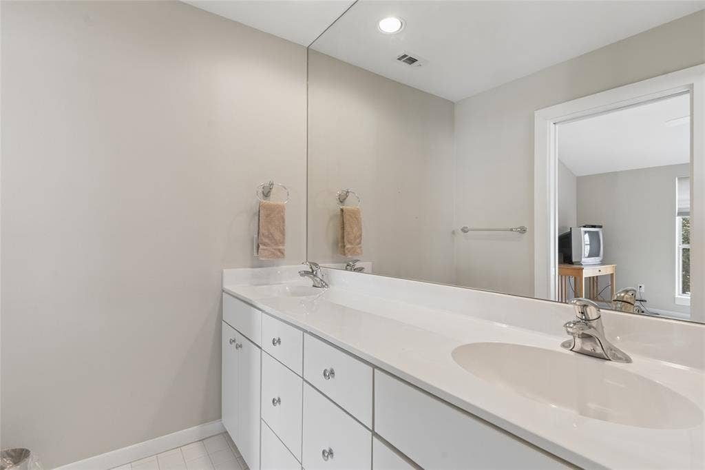 2714 Shelby Avenue, Dallas, TX 75219 Double vanity with integrated sinks, chrome faucets, and clear cabinet hardware