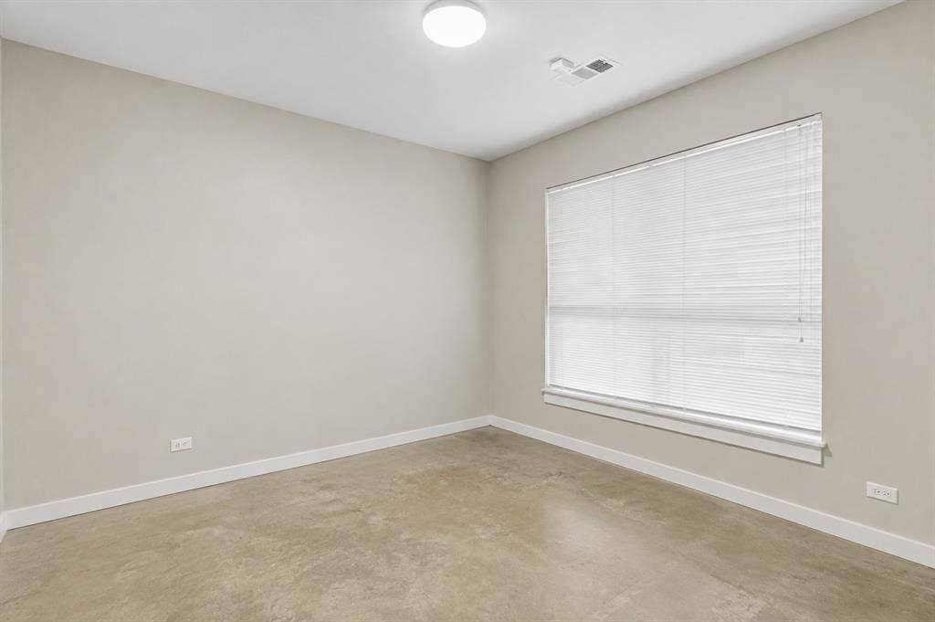 2714 Shelby Avenue, Dallas, TX 75219 Neutral wall color, concrete-finish flooring, large window with blinds, ceiling-mounted light fixture, white trim
