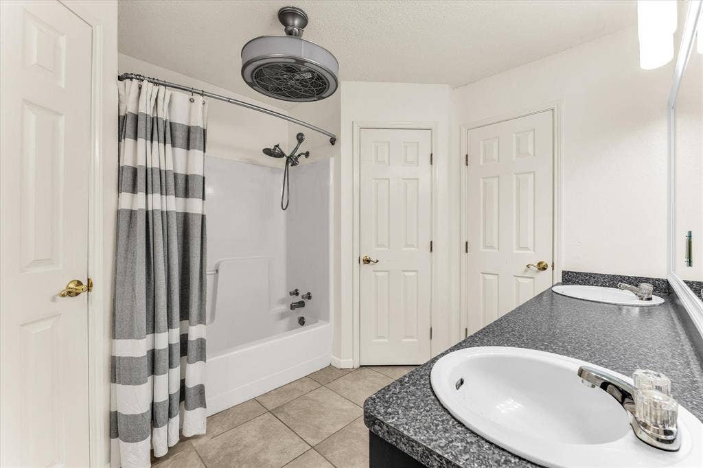 4626 Lexington Street, Bellmead, TX 76705 Dual vanity with undermount sinks, speckled countertop, and chrome fixtures