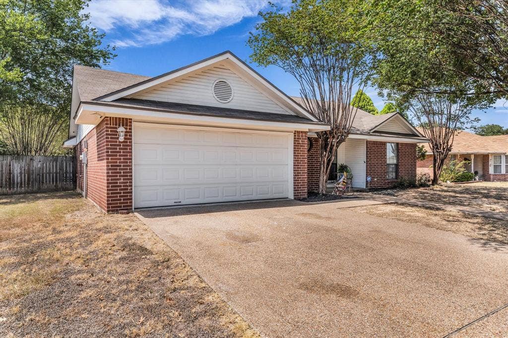 4626 Lexington Street, Bellmead, TX 76705 Brick exterior with white siding accents and an attached garage