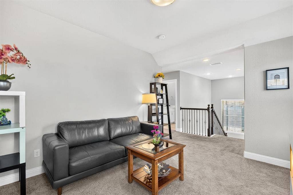 8226 Natchez Trail, Dallas, TX 75252 Carpeted landing with a decorative iron railing and recessed lighting