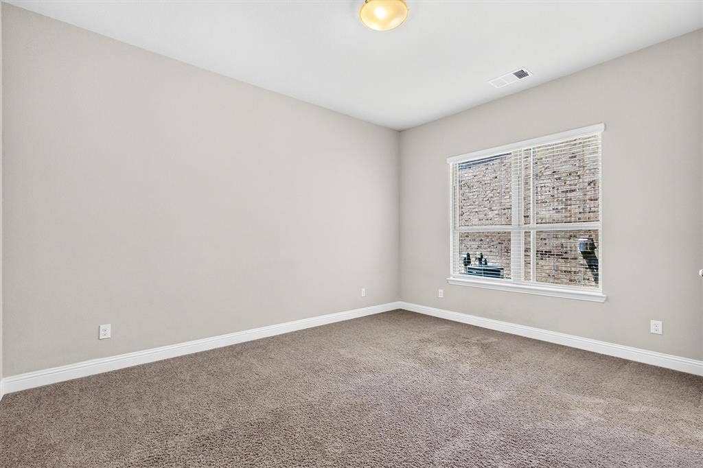 8226 Natchez Trail, Dallas, TX 75252 Neutral painted walls, wall-to-wall carpeting, and a window with blinds