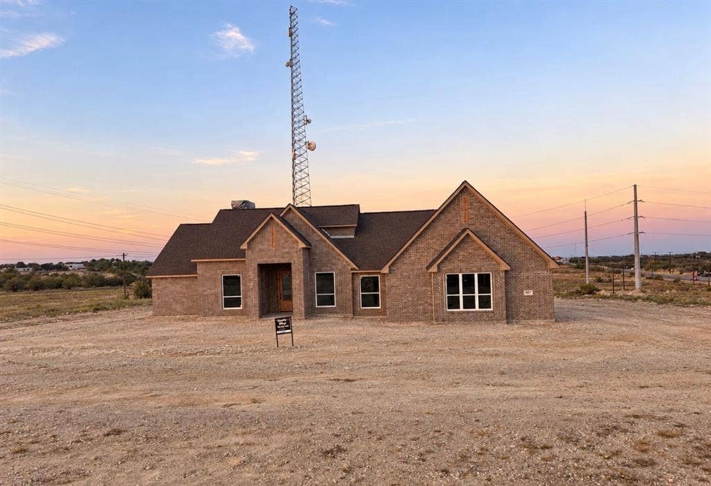 457 Collum View, Azle, TX 76020 Brick exterior with a gabled roofline and multiple window configurations