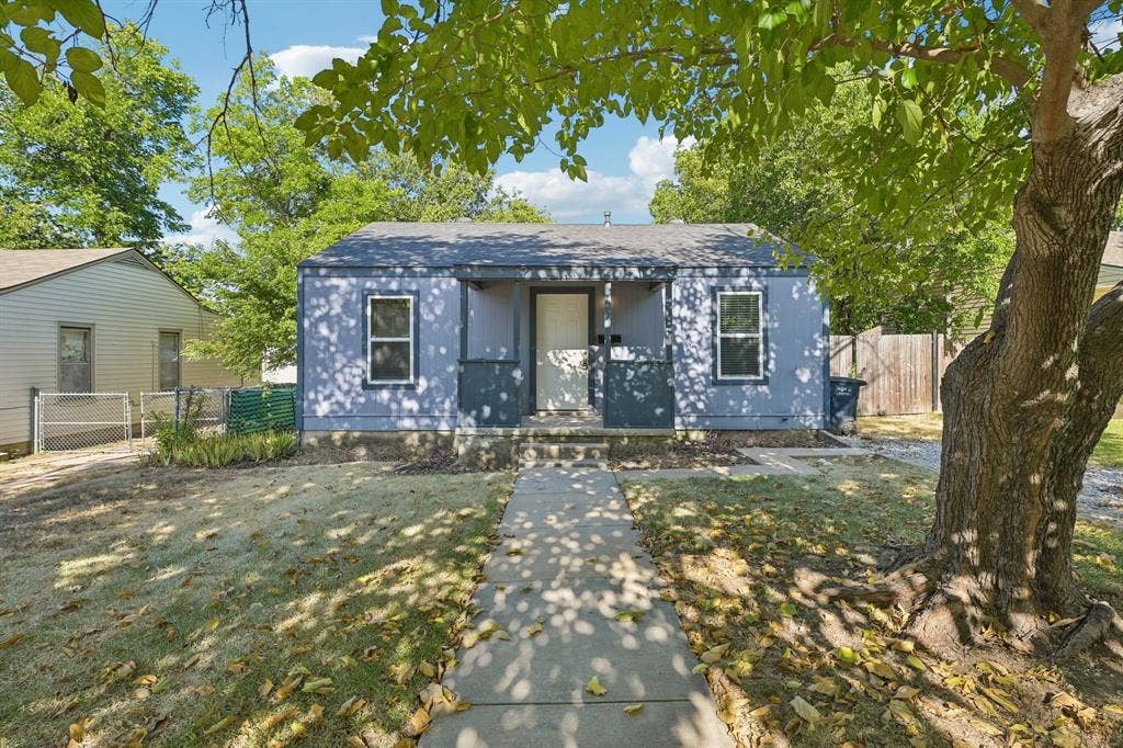 5012 Pamela Drive, Fort Worth, TX 76116 Single-story residence with a light blue exterior, featuring a gray shingle roof and white trim windows