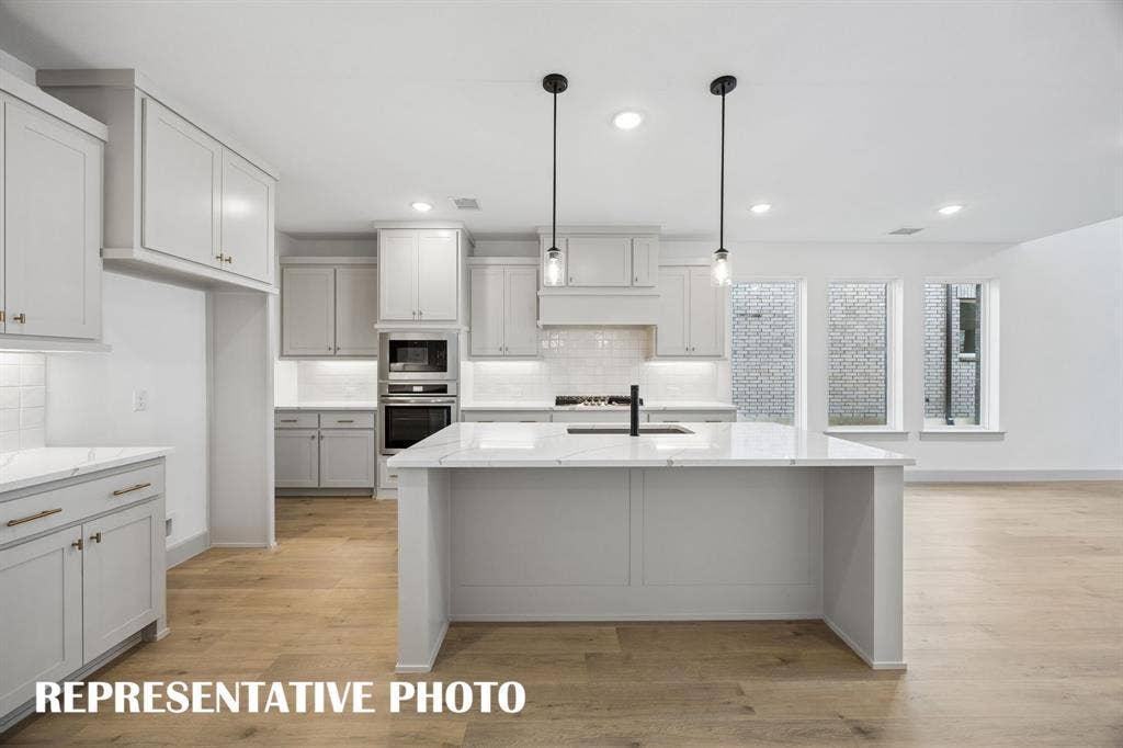 2629 Radiant Way, Celina, TX 75009 The spacious island is the hub of your new dream kitchen and offers the perfect place for friends and family to gather round!