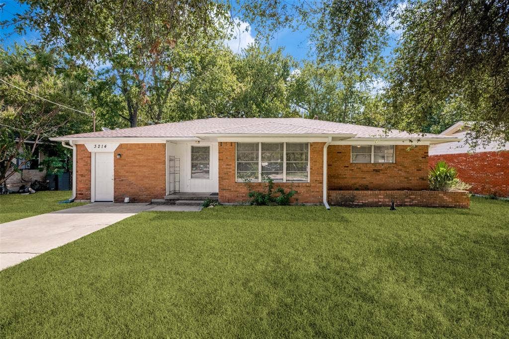 3214 Avon Street, Denton, TX 76209 Brick exterior with a white fascia and downspout