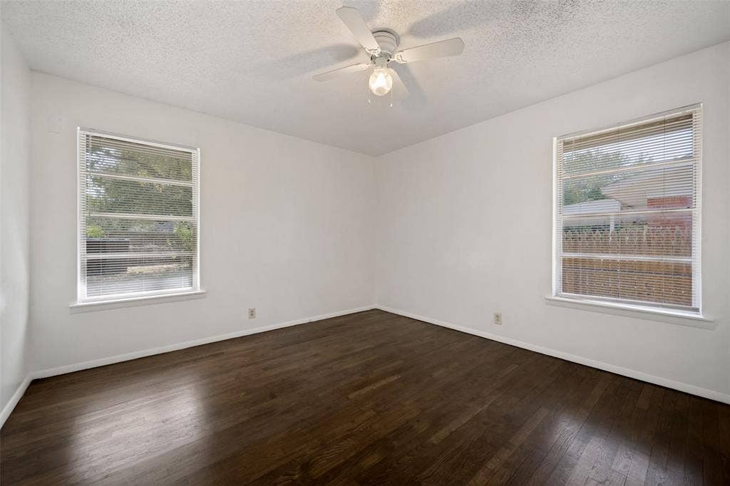 3214 Avon Street, Denton, TX 76209 Wood-finish flooring, white walls, and a ceiling fan with integrated lighting