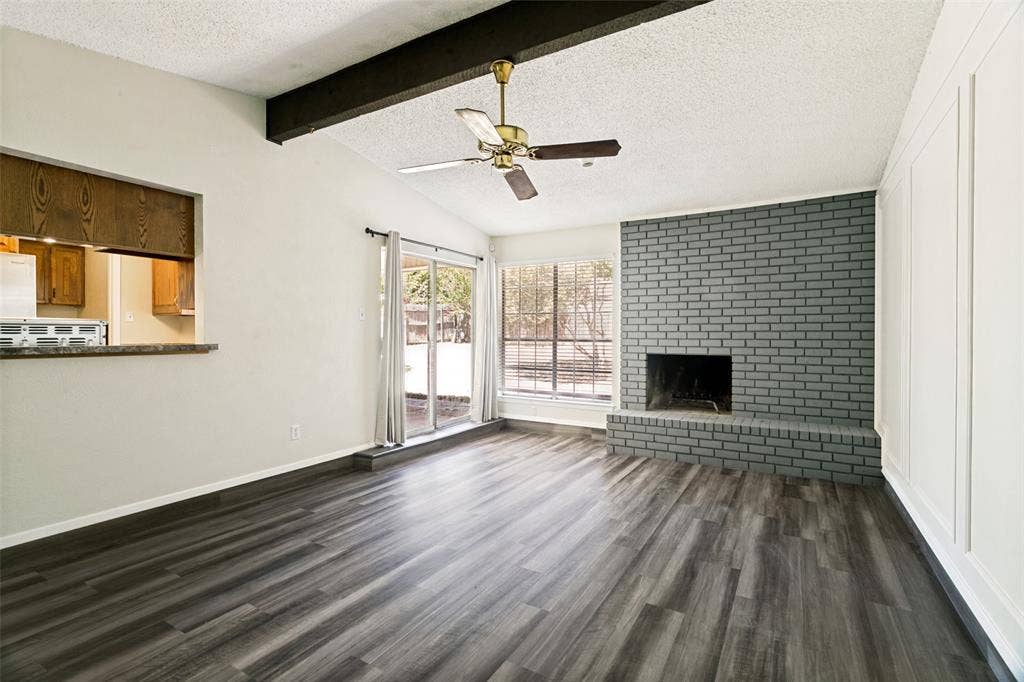 Gather and relax in the inviting living room featuring brand-new flooring and plenty of space for seating and entertaining. A fireplace adds warmth and character to this welcoming space.