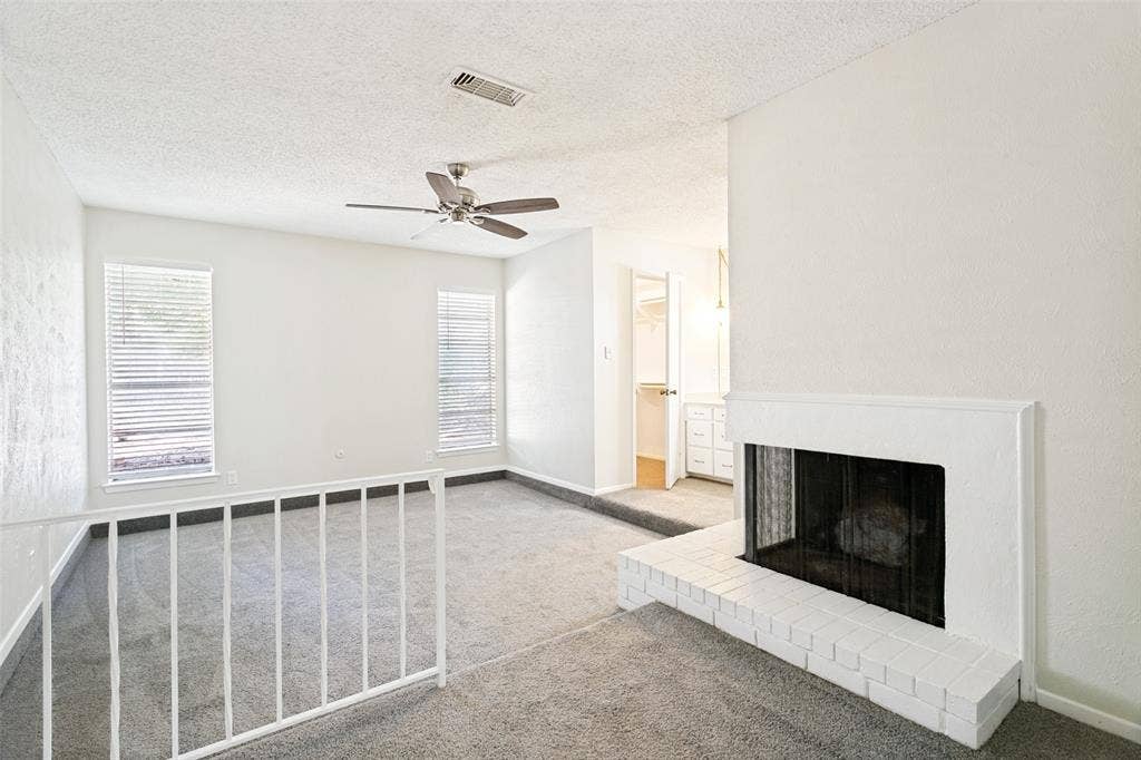 Relax and unwind in the spacious primary bedroom featuring brand-new carpet and a fireplace, plenty of room for comfortable furnishings. A peaceful retreat at the end of the day!