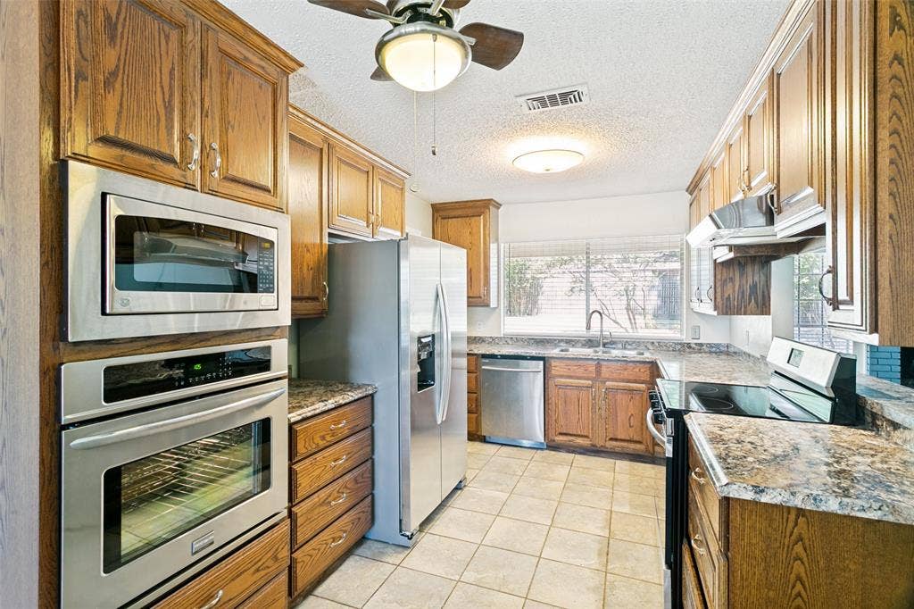 The kitchen features a refrigerator and two ovens, offering plenty of convenience and cooking space.