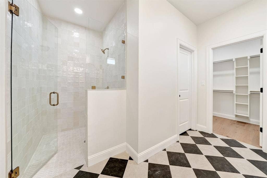 302 Grace Lane, Athens, TX 75751 Primary bathroom featuring a stand alone soaking tub, walk-n tiled shower & walk-in closet.