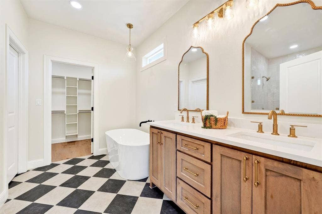 302 Grace Lane, Athens, TX 75751 Primary bathroom featuring a stand alone soaking tub, walk-n tiled shower & walk-in closet.
