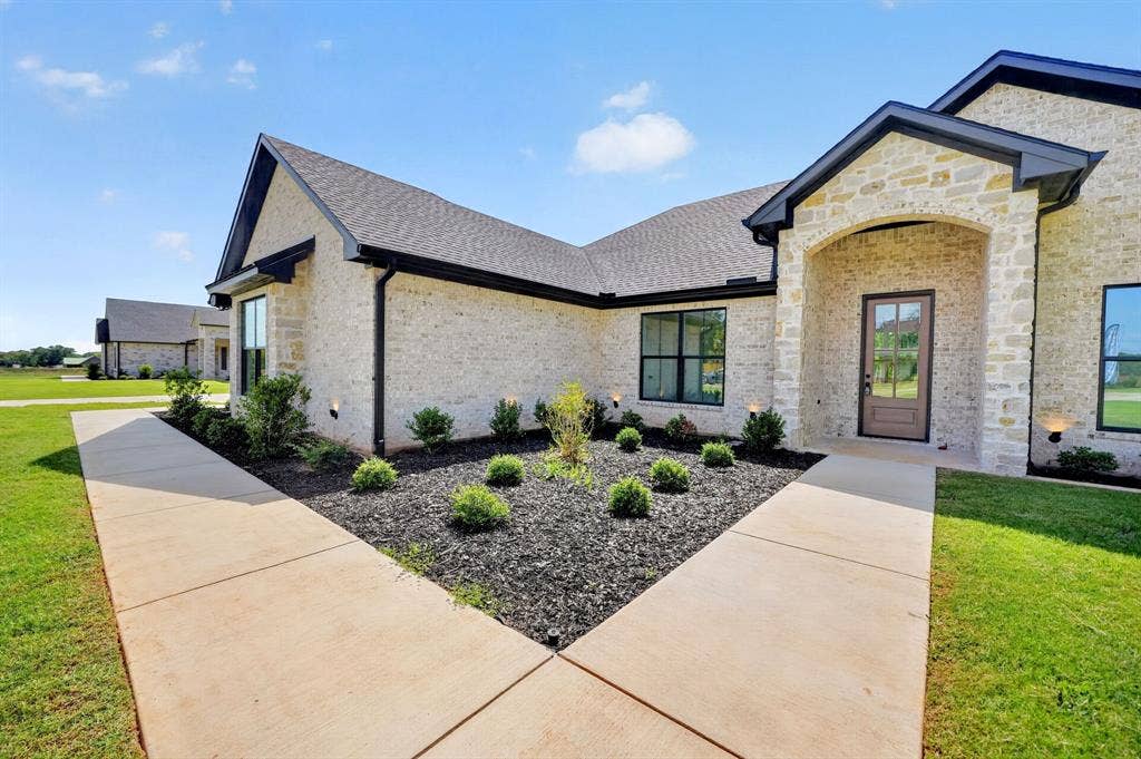 302 Grace Lane, Athens, TX 75751 Front entrance of 302 Grace Lane features a landscaped entrance with irrigation installed for easy maintenance.
