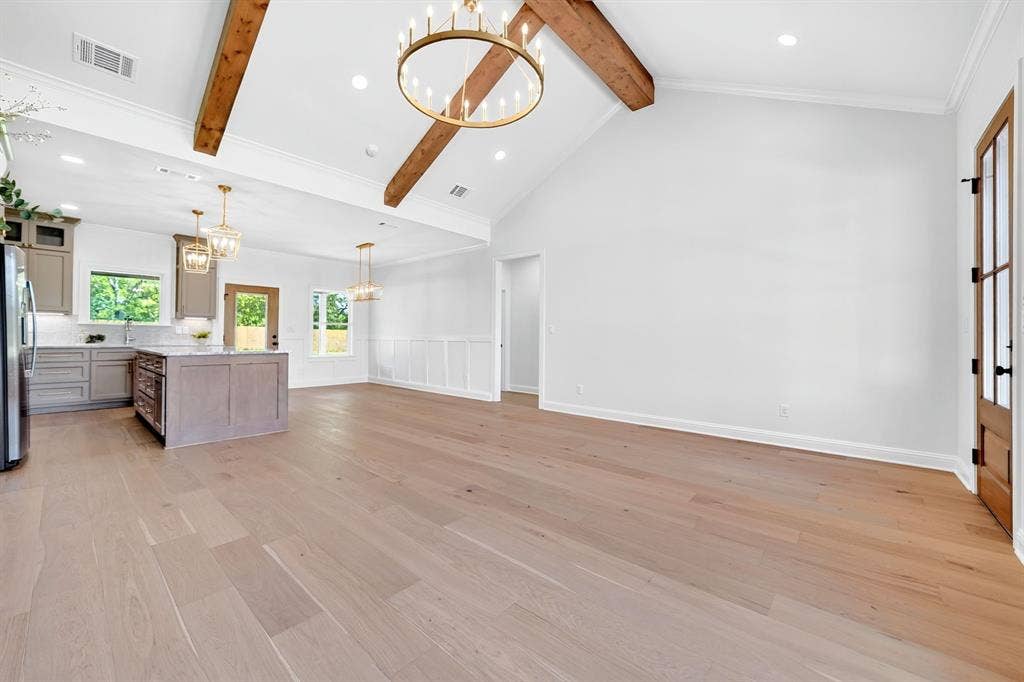 305 Grace Lane, Athens, TX 75751 Vaulted ceilings with exposed wood beams, wood-finish flooring, recessed lighting, kitchen island with countertop, and modern cabinetry