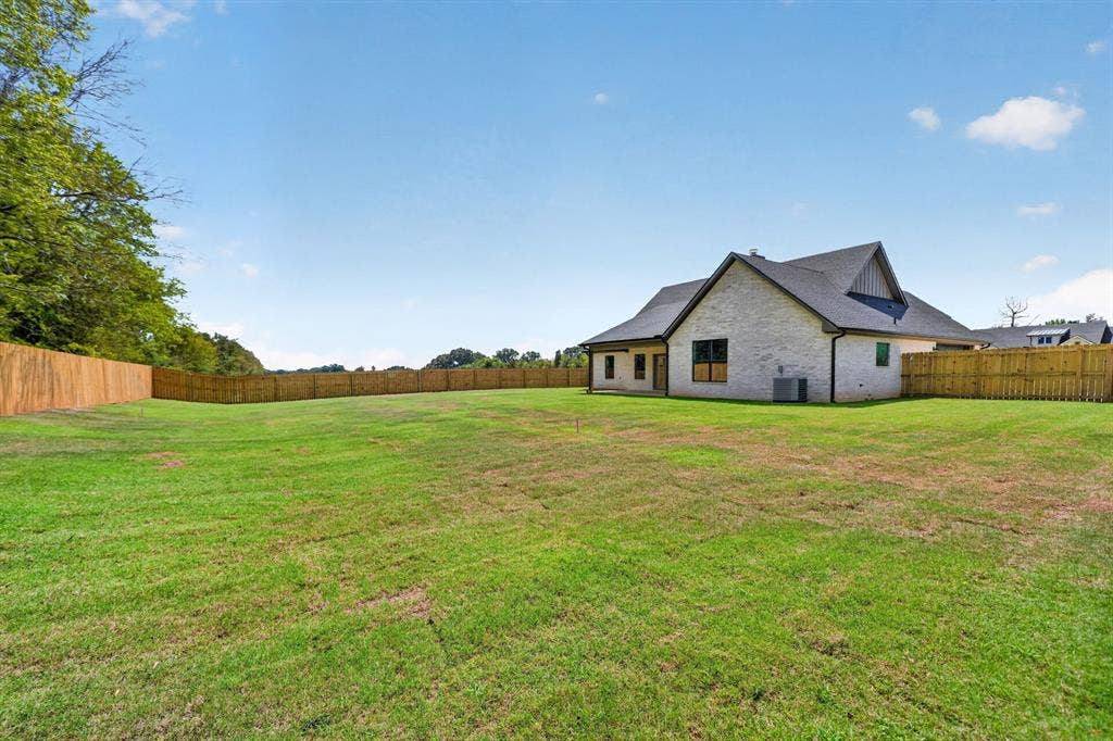 305 Grace Lane, Athens, TX 75751 Expansive green lawn with a full privacy fence