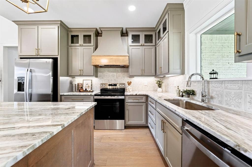 305 Grace Lane, Athens, TX 75751 Kitchen featuring wood-finish flooring, light-toned cabinetry, stainless steel appliances, and stone countertops
