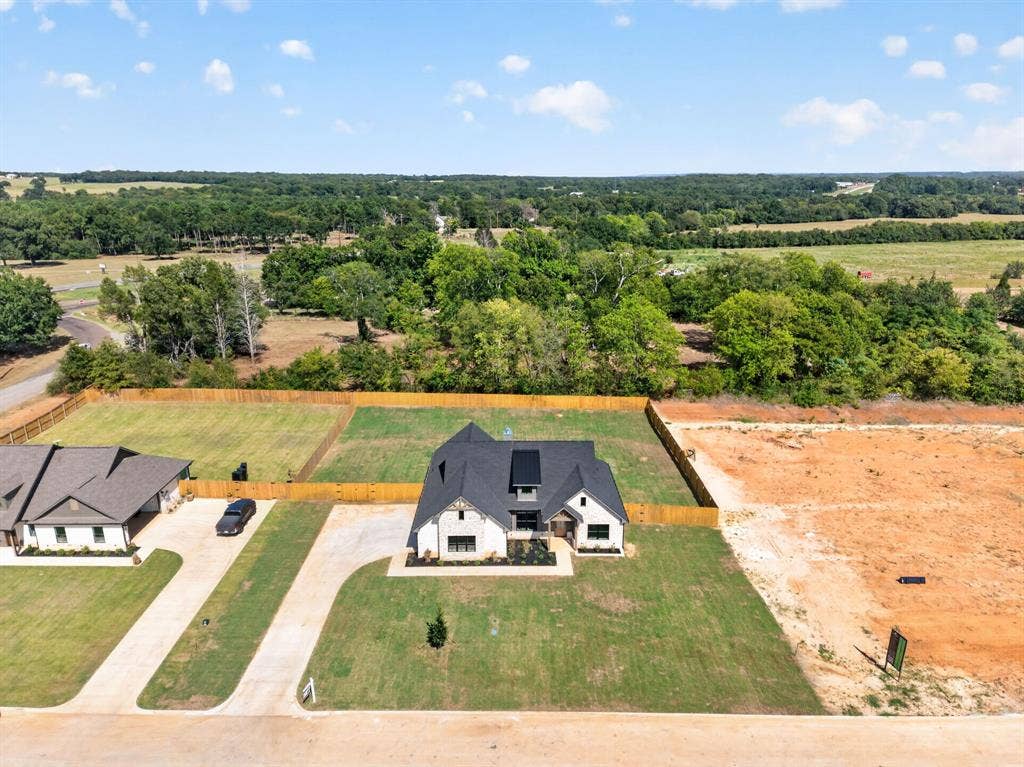 305 Grace Lane, Athens, TX 75751 Stone and brick exterior with black-framed windows and dark trim