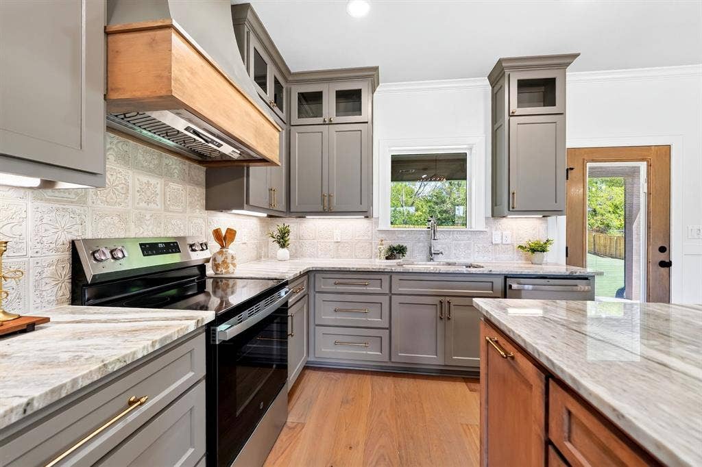 305 Grace Lane, Athens, TX 75751 Kitchen featuring gray shaker-style cabinetry, light-toned countertops, tile backsplash, and stainless steel appliances