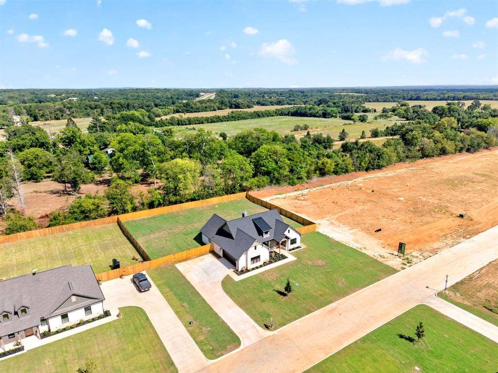 305 Grace Lane, Athens, TX 75751 Contemporary farmhouse-style residence with a dark-pitched roof and light-colored siding