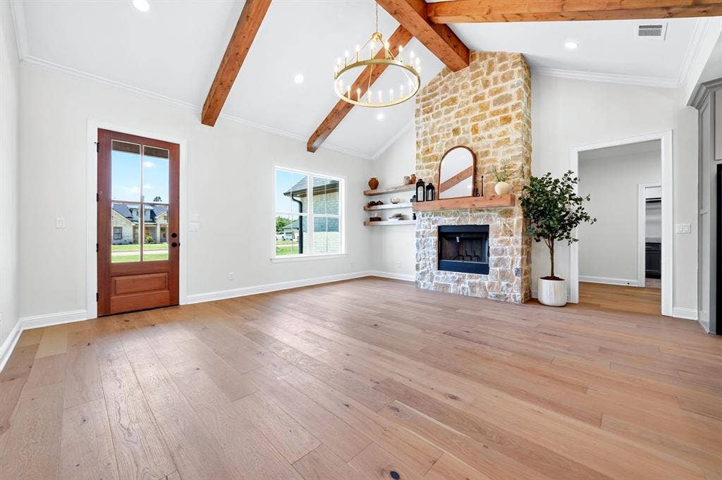 305 Grace Lane, Athens, TX 75751 Vaulted ceiling with exposed wood beams, stone fireplace, wood-finish flooring, and recessed lighting