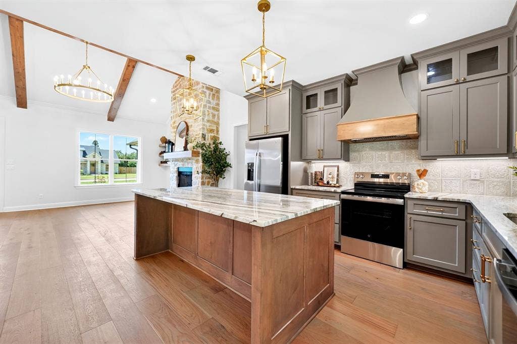 305 Grace Lane, Athens, TX 75751 Spacious kitchen featuring an island with stone countertop, stainless steel appliances, and gray cabinetry