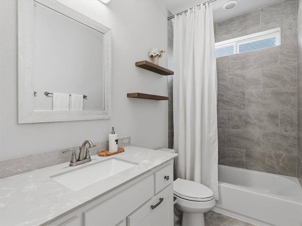 3505 Wycliff Avenue, McKinney, TX 75071 Vanity with white shaker-style cabinetry, undermount sink, and light-toned countertop