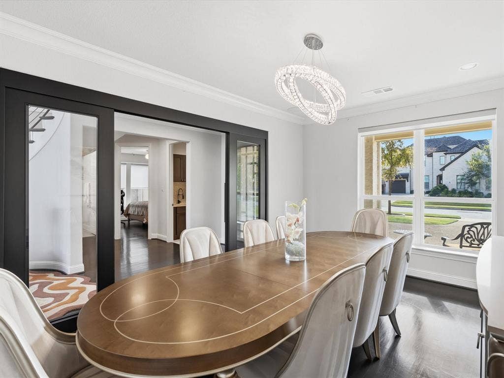 3505 Wycliff Avenue, McKinney, TX 75071 Recessed lighting, crown molding, a modern crystal chandelier, dark wood-finish flooring, and expansive windows