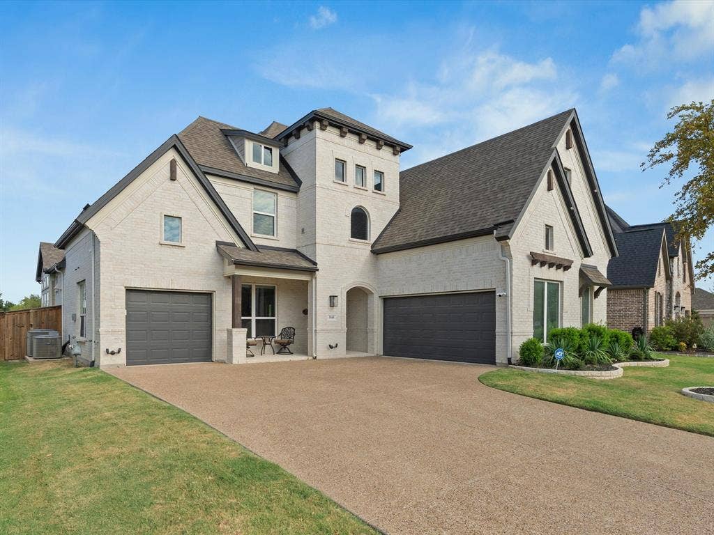 3505 Wycliff Avenue, McKinney, TX 75071 Striking two-story residence featuring a cream and stone exterior with multiple peaked rooflines and architectural detail