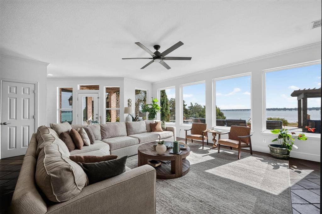 4016 Stone Haven Drive, Garland, TX 75043 Spacious living area featuring expansive windows, beautiful flooring, and a ceiling fan
