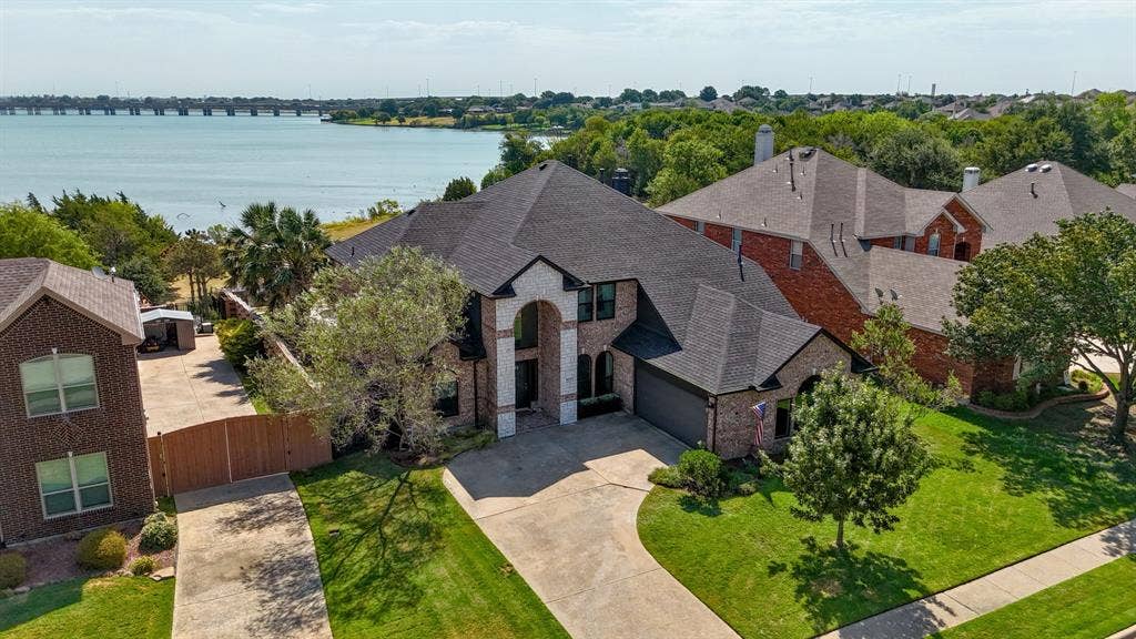 4016 Stone Haven Drive, Garland, TX 75043 Brick exterior with a stone accent facade and dark shingle roof