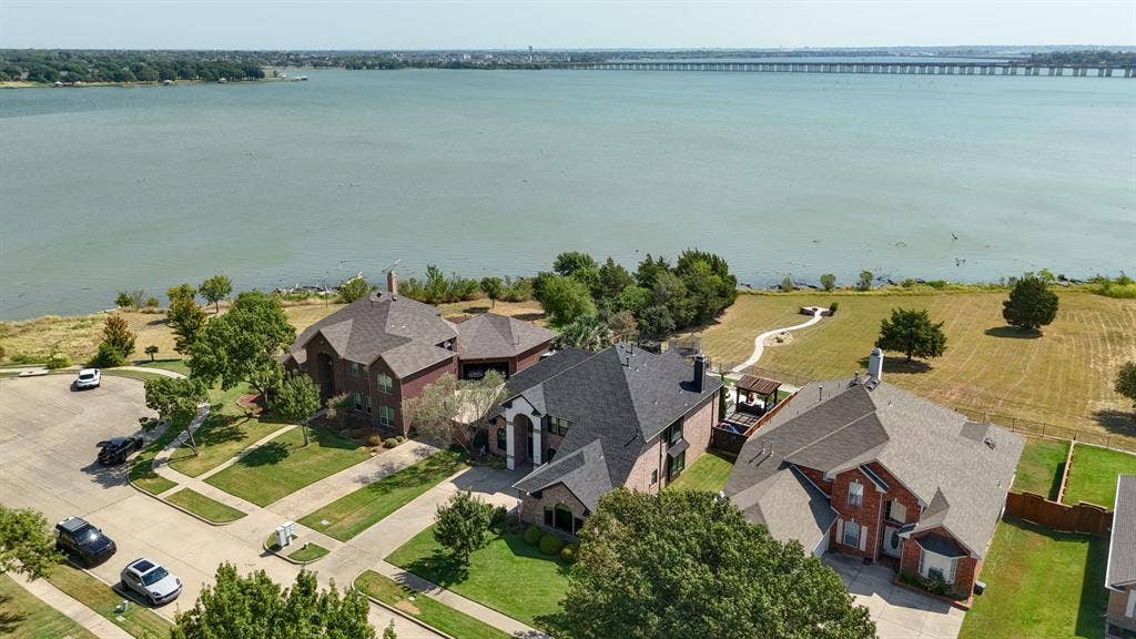 4016 Stone Haven Drive, Garland, TX 75043 Waterfront property with a large body of water, paved roadways, and mature trees