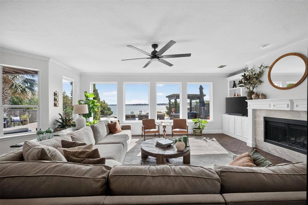 4016 Stone Haven Drive, Garland, TX 75043 Spacious living area featuring a contemporary ceiling fan, and a built-in media console with storage