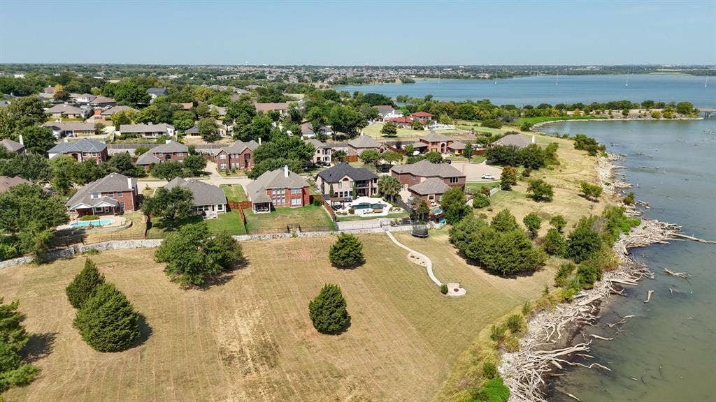 4016 Stone Haven Drive, Garland, TX 75043 Waterfront residential setting with established landscaping and a large body of water