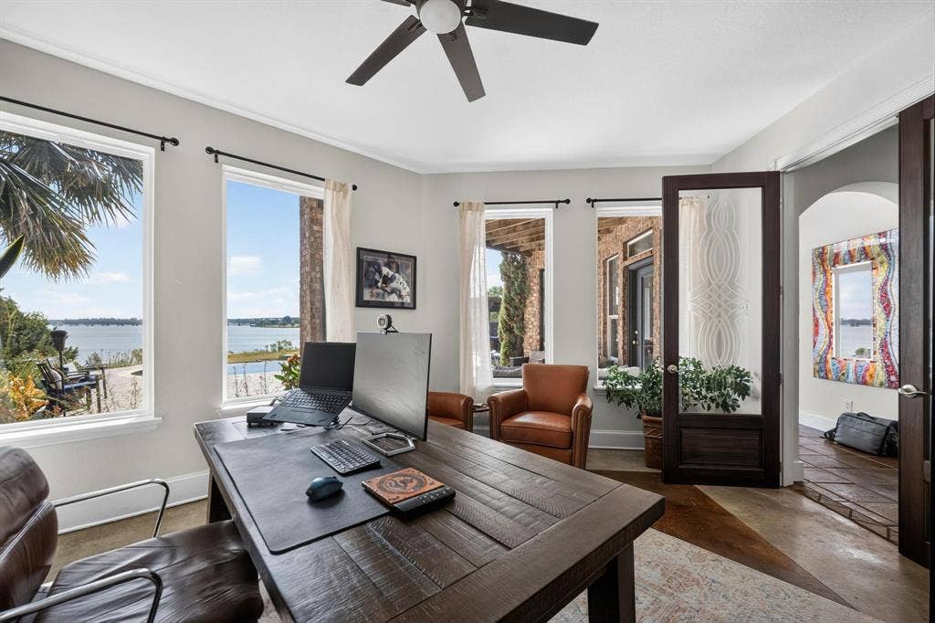 4016 Stone Haven Drive, Garland, TX 75043 Room featuring multiple windows, a ceiling fan and a dark wood-finish paneled door with glass insert