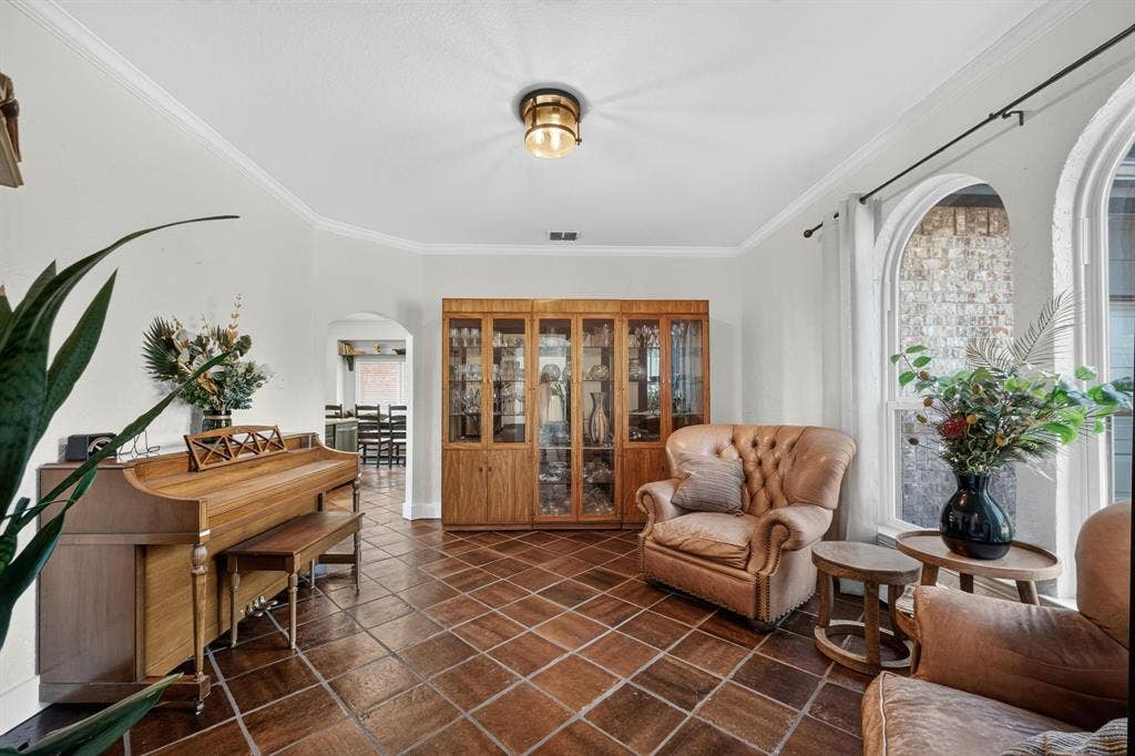 4016 Stone Haven Drive, Garland, TX 75043 Arched windows, beautiful flooring, crown molding, built-in display cabinetry, and a brass-tone flush-mount light fixture
