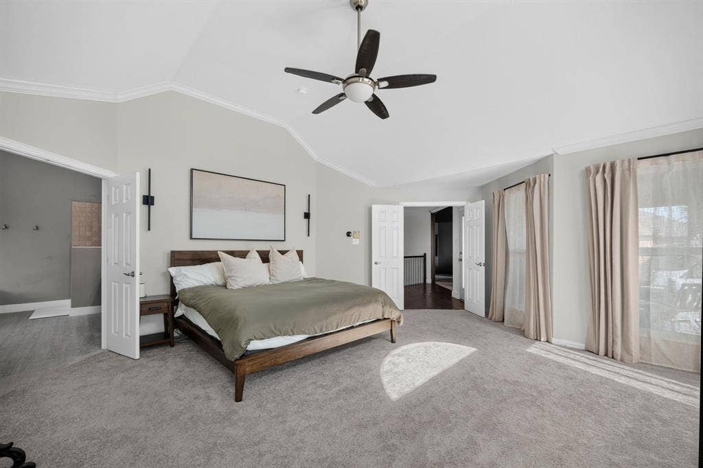 4016 Stone Haven Drive, Garland, TX 75043 Vaulted ceiling with crown molding, ceiling fan, carpet flooring, and double-panel doors