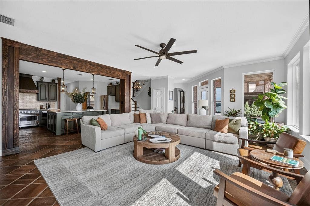 4016 Stone Haven Drive, Garland, TX 75043 Spacious living area featuring exposed wood beams, and multiple windows