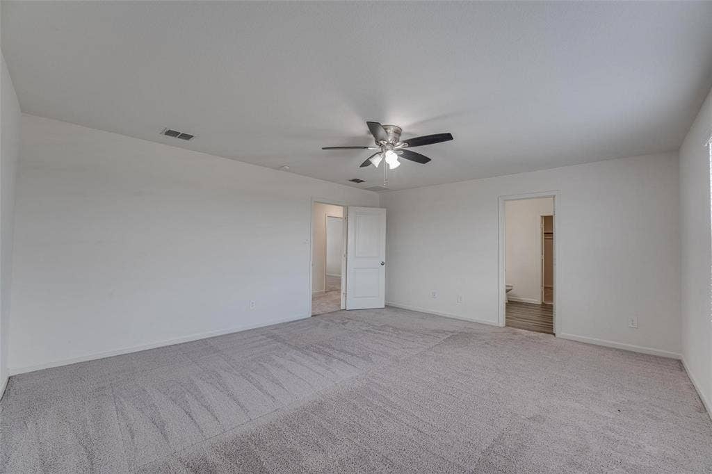 767 Camden Drive, Lavon, TX 75166 Spacious carpeted room featuring a ceiling fan with integrated lighting and multiple doorways