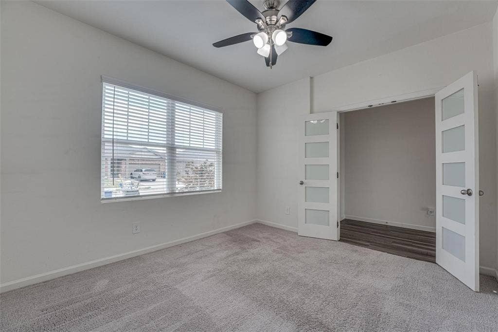 767 Camden Drive, Lavon, TX 75166 Light gray carpeted flooring, a ceiling fan with integrated lighting, and a window with horizontal blinds