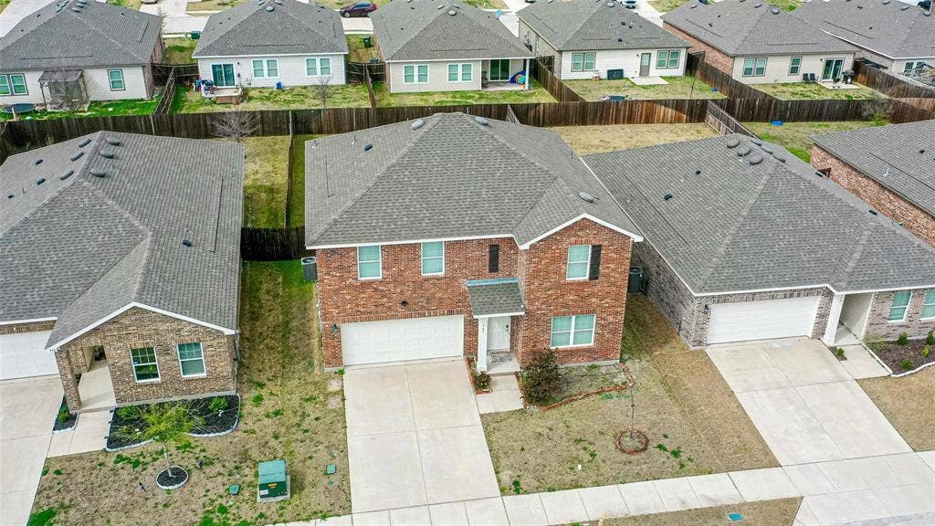 767 Camden Drive, Lavon, TX 75166 Two-story brick facade residence with an attached two-car garage, concrete driveway, and front landscaping