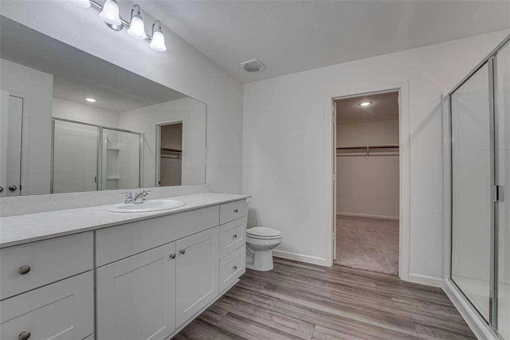 767 Camden Drive, Lavon, TX 75166 Bathroom featuring a white vanity with extensive counter space, an integrated sink, and white cabinetry
