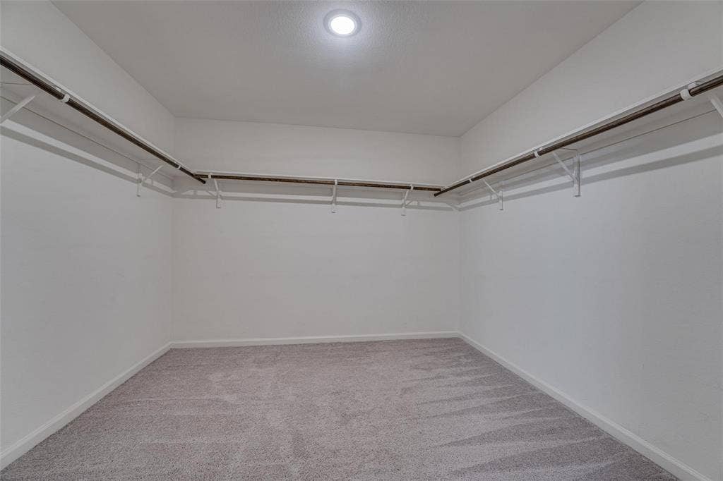 767 Camden Drive, Lavon, TX 75166 Recessed ceiling lighting, wall-mounted hanging rods, wire shelving, light grey carpeting, and neutral wall paint