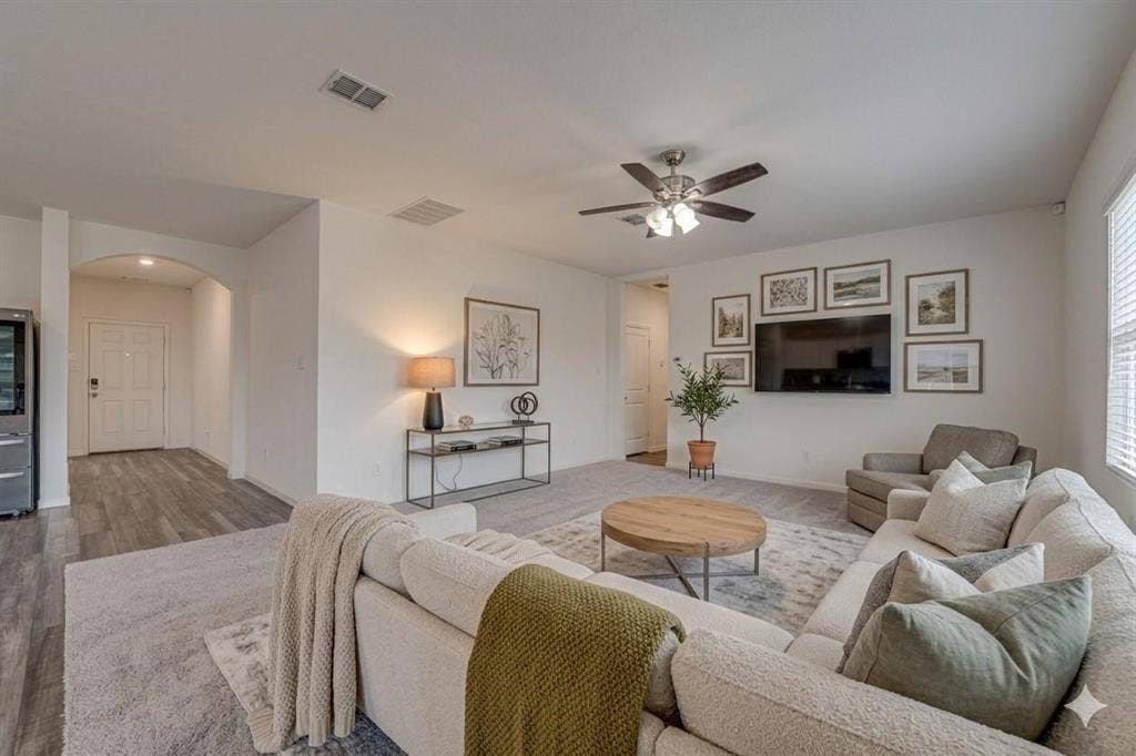 767 Camden Drive, Lavon, TX 75166 Spacious open-concept living area featuring a ceiling fan, arched doorway, and wood-finish flooring