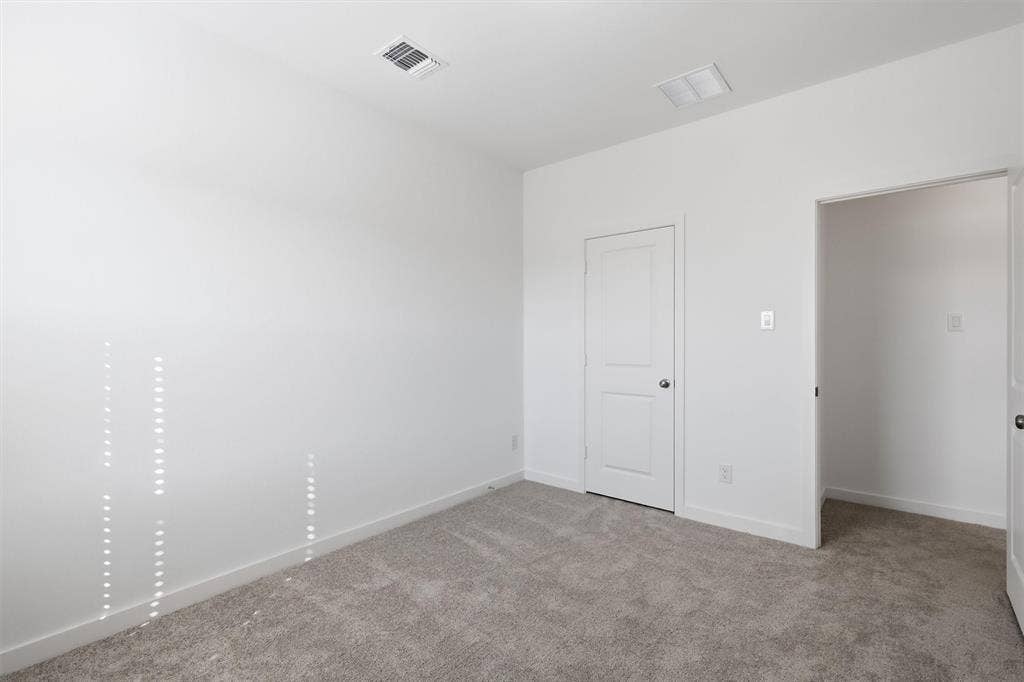 7621 Dakota, Watauga, TX 76148 Neutral wall color, carpet flooring, and white trim