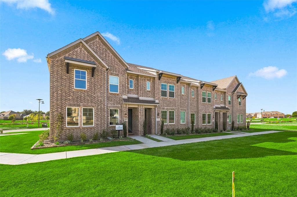 7621 Dakota, Watauga, TX 76148 Brick exterior with gabled rooflines, dark window awnings, and an arched entryway