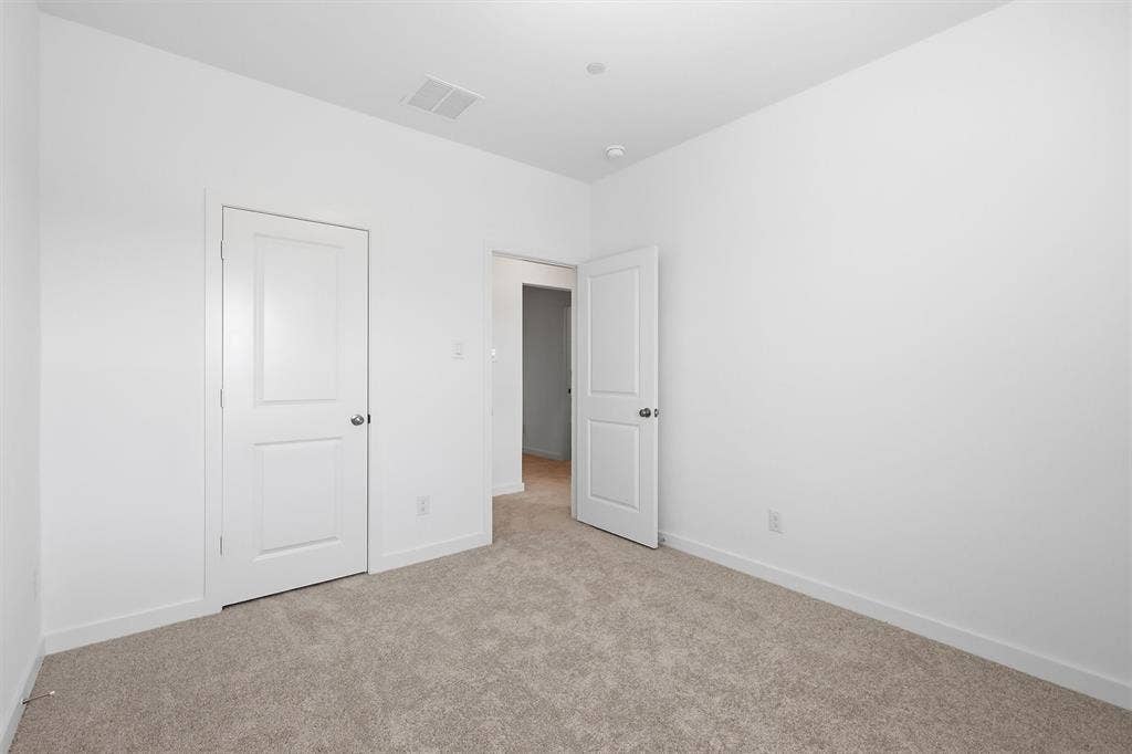 7621 Dakota, Watauga, TX 76148 Textured carpet flooring, white walls, and a recessed ceiling light
