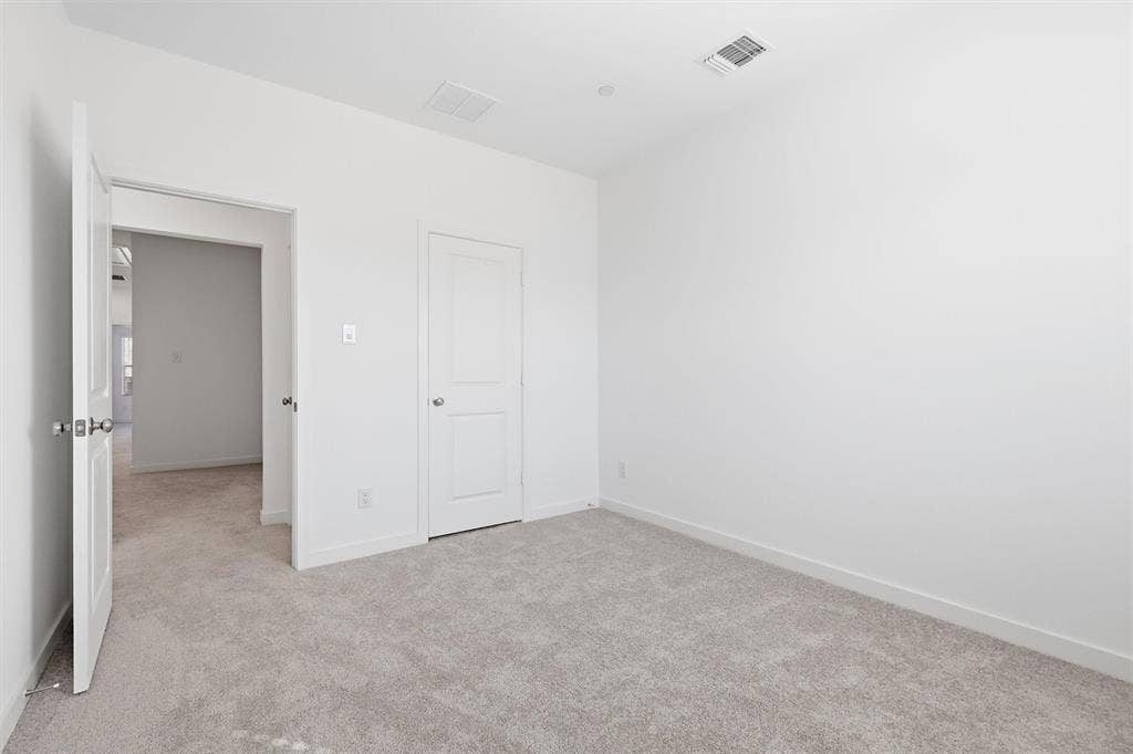7621 Dakota, Watauga, TX 76148 Neutral-toned carpet flooring and white painted walls create a blank canvas