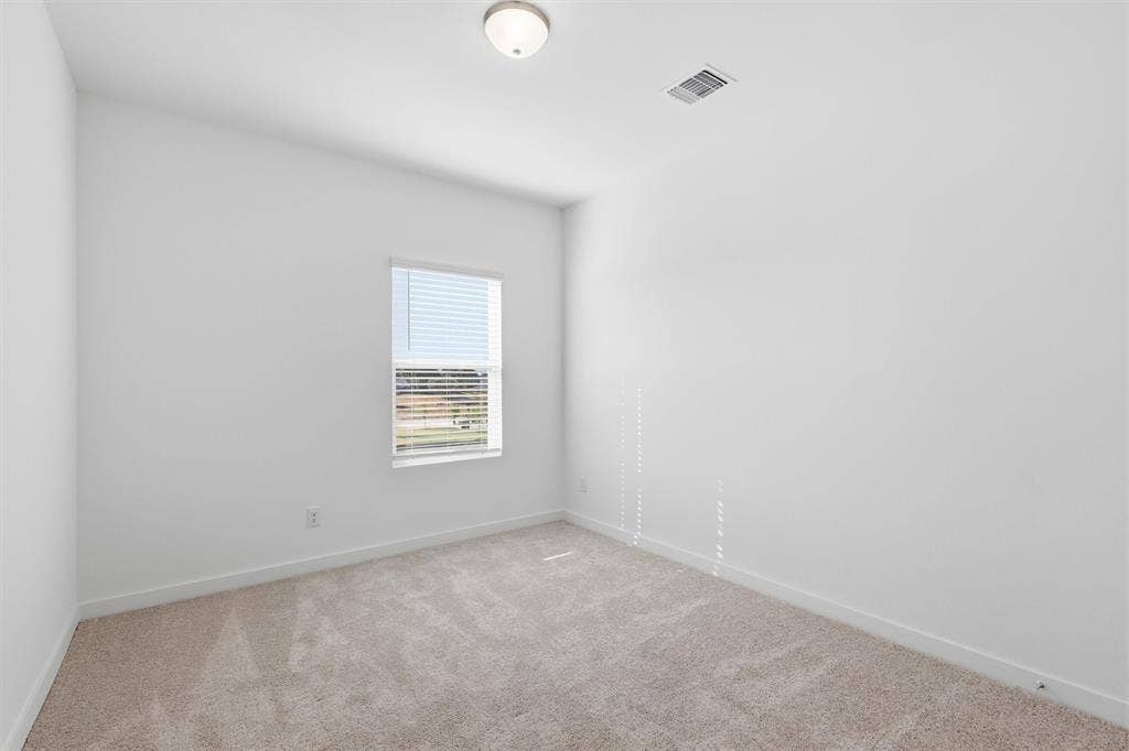 7621 Dakota, Watauga, TX 76148 Wall-to-wall carpeting, window with blinds, ceiling-mounted light fixture, and white painted walls