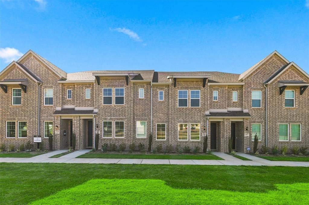 7621 Dakota, Watauga, TX 76148 Brick exterior with dark roof shingles, multiple windows, and covered entryways